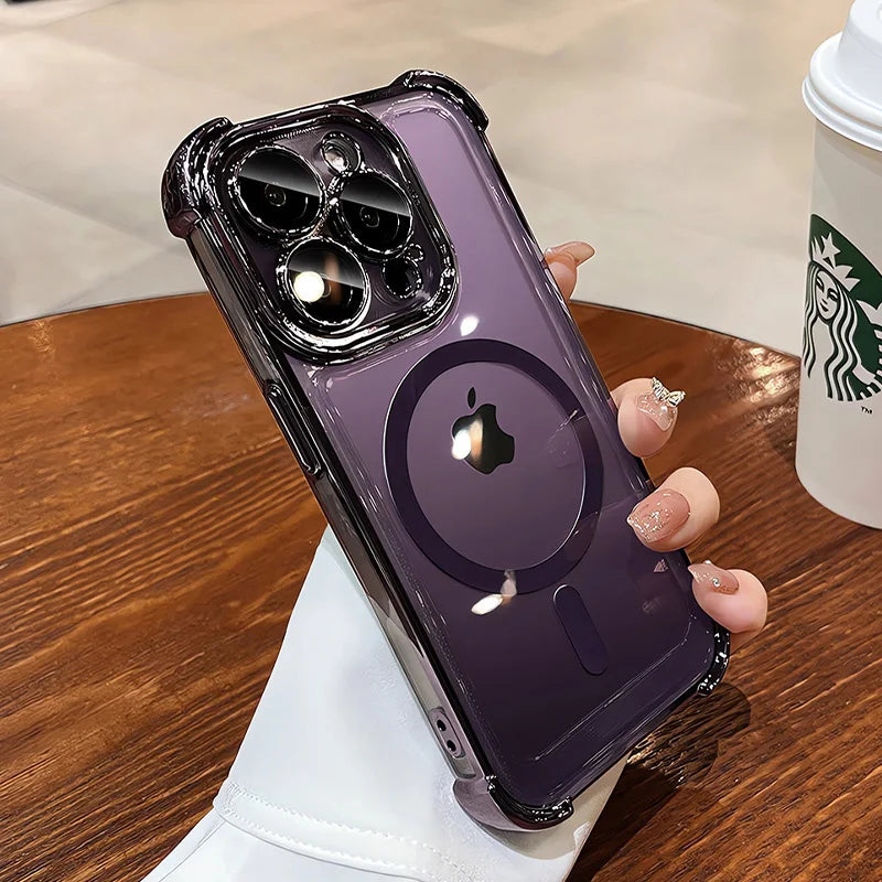 Person holding a purple phone case with Apple logo on a wooden table with a Starbucks cup.