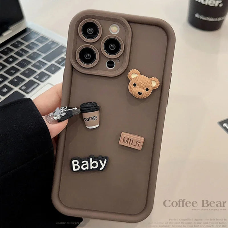 This image features a custom iPhone case with a playful 3D cartoon design. The case is predominantly white and showcases a series of raised elements including a bear, a camera, and text that reads "Baby" and "Milk".
