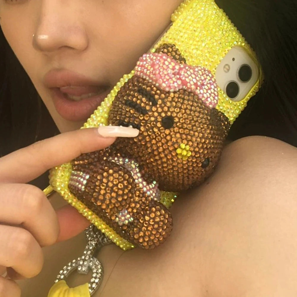 A collection of iPhone cases and accessories with Hello Kitty design, predominantly in pink and other colors, adorned with sequins and crystals.