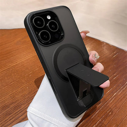Black phone case with a stand feature held by a hand on a wooden surface.