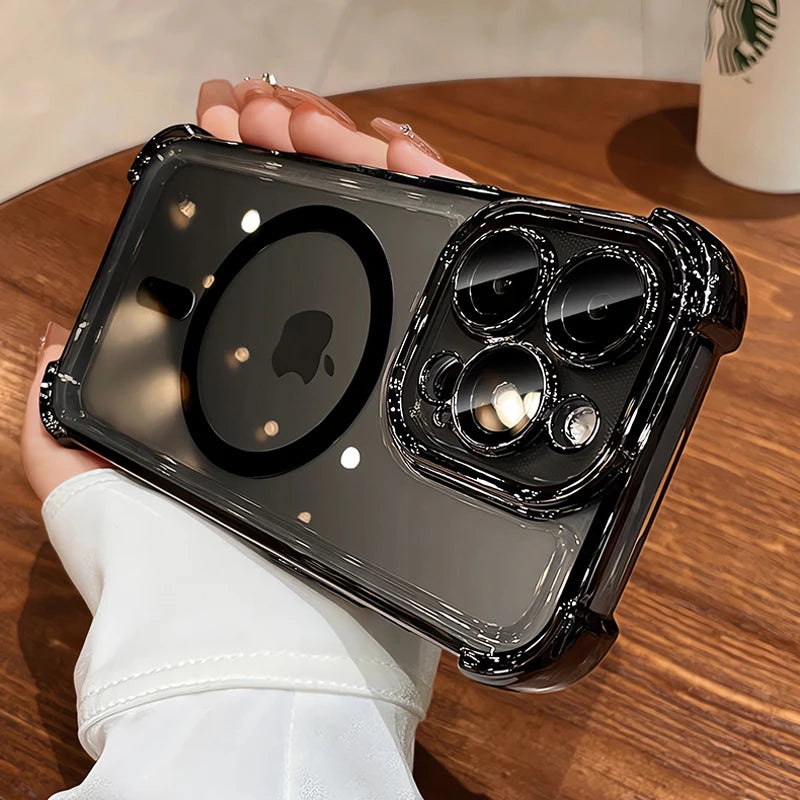 Person holding a clear phone case with black accents on a wooden table.