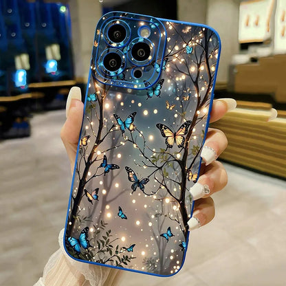 A person holding a blue iPhone case with a pattern of dark butterfly silhouettes and stars.