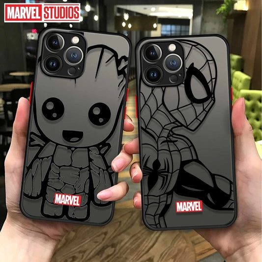 Two cell phone cases held in hands, one with a cartoonish character and the other with a spider-man design, both with 'MARVEL STUDIOS' branding.