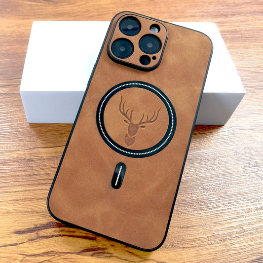 A brown faux leather mobile phone case with a magnetic attachment point, featuring a stamped animal head design in the center, displayed on a wooden surface with a white box in the background.