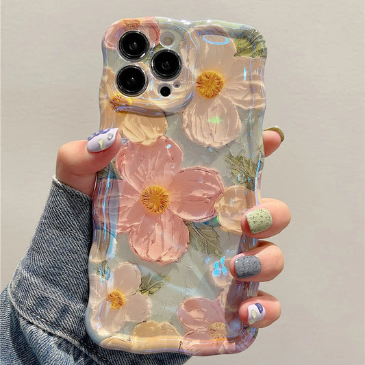 A person holding a mobile phone with a multicolored floral case.