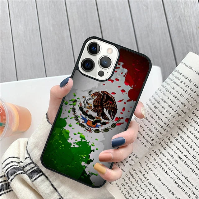 Phone case with Mexican flag design held by a person over a book.